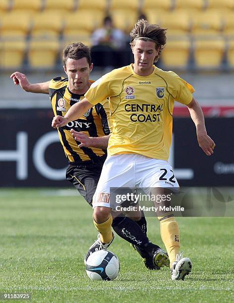 Nicky Travis of the Mariners is tackled by Tim Brown of the Phoenix during the round eight A-League match between the Wellington Phoenix and the...