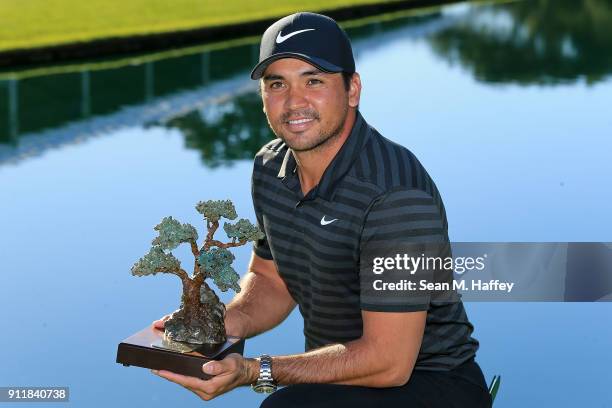 Jason Day of Australia poses with the trophy after the sixth playoff on the 18th hole to win the Farmers Insurance Open at Torrey Pines South on...