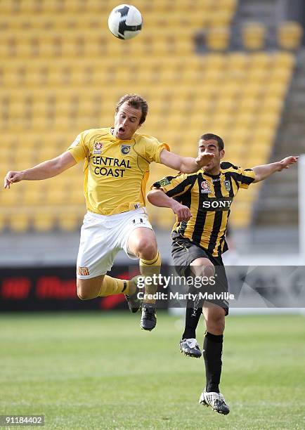 Manny Muscat of the Phoenix jumps for the ball with Dylan Macallister of the Mariners during the round eight A-League match between the Wellington...