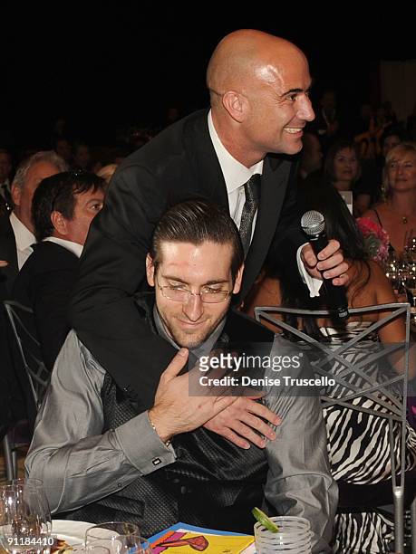 Former tennis player Andre Agassi hugs an auction donor during the 14th annual Andre Agassi Foundation for Education's Grand Slam for Children...