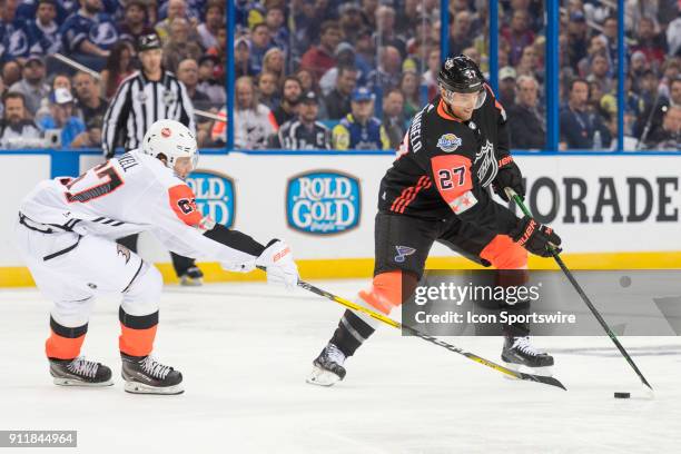 Central Division defender Alex Pietrangelo avoids the stick-check by Pacific Division forward Rickard Rakell during the first game of the NHL...