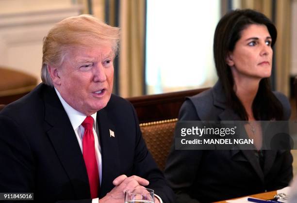 President Donald Trump speaks watched by US Ambassador to the UN Nikki Haley during lunch with members of the United Nations Security Council in the...
