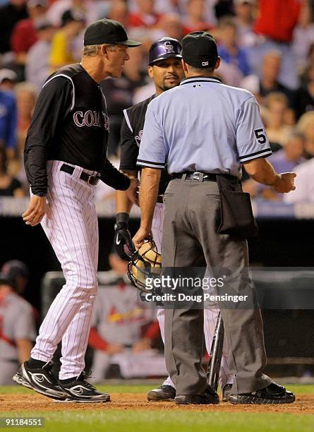 Manager Jim Tracy of the Colorado Rockies intervenes as Yorvit Torrealba of the Rockies argues a third strike with homeplate umpire Dan Iassogna...