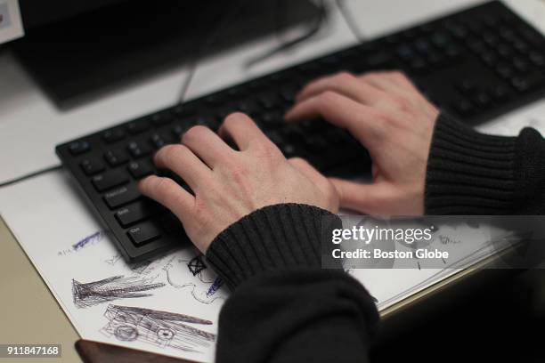 Jarrod LaBarge, a volunteer at the Samaritans suicide hotline, works in his cubicle during a shift in Boston on Dec. 15, 2017. LaBarge assists...