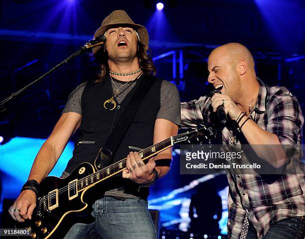 Musicians Josh Steely and singer Chris Daughtry of the band Daughtry performs during the 14th annual Andre Agassi Foundation for Education's Grand...