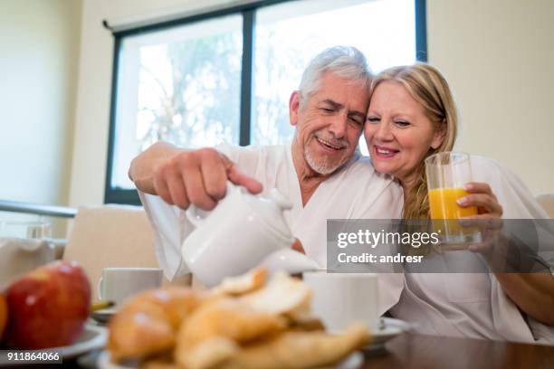 couple at a hotel enjoying roomservice breakfast - continental breakfast stock pictures, royalty-free photos & images