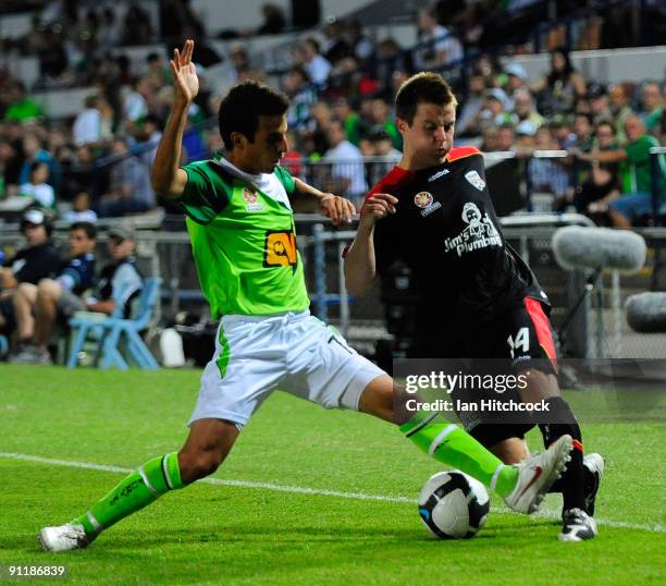 Jason Spagnuolo of the Fury tackles Scott Jamieson of Adelaide United during the round eight A-League match between the North Queensland Fury and...