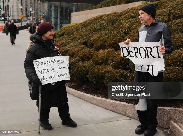 Pro Donald Trump protester holds up sign calling for deportation as dozens of immigration activists, clergy members and others participate in a...
