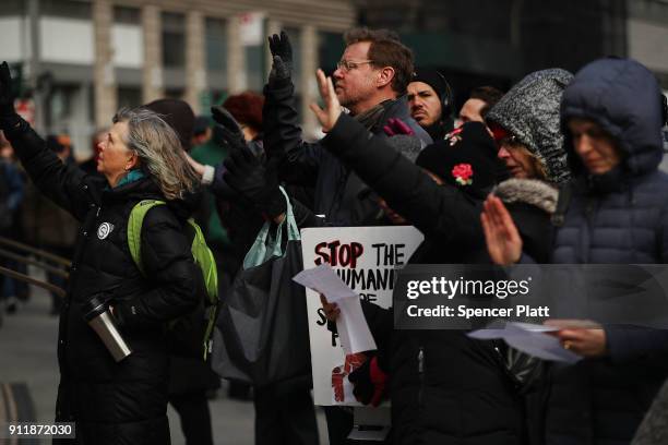 Pro Donald Trump protester holds up a sign calling for deportation as dozens of immigration activists, clergy members and others participate in a...