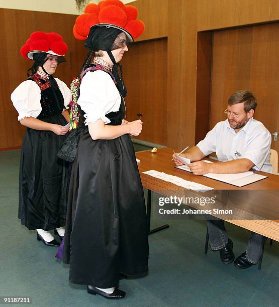 Claudia Lutz and Christiane Huber of Kirnbacher Kurrende Black Forest costume club arrive for casting their vote for the German federal elections on...