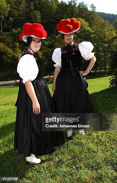 Claudia Lutz and Christiane Huber of Kirnbacher Kurrende Black Forest costume club pose in front of an old farmhouse after casting their vote for the...