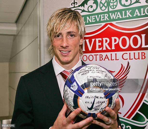 Fernando Torres of Liverpool poses with his 'hat trick ball' signed by his team mates after the Barclays Premier League match between Liverpool and...