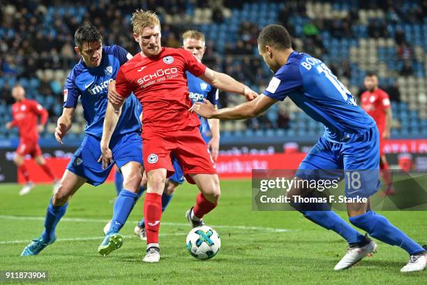 Anthony Losilla and Jan Gyamerah of Bochum tackle Andreas Voglsammer of Bielefeld during the Second Bundesliga match between VfL Bochum 1848 and DSC...