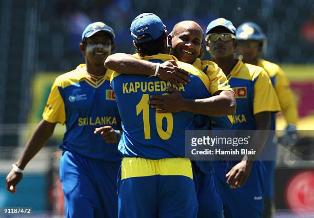 Sanath Jayasuriya of Sri Lanka celebrates with team mate Chamara Kapugedera after taking the wicket of Daniel Vettori of New Zealand during the ICC...