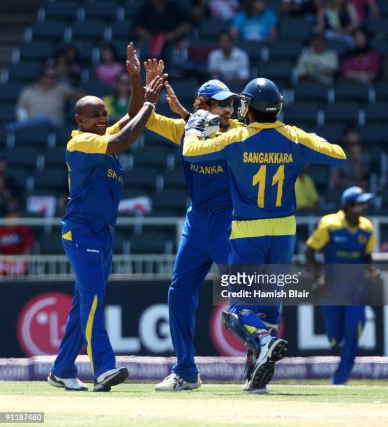 Sanath Jayasuriya of Sri Lanka celebrates with team mates after taking the wicket of Neil Broom of New Zealand during the ICC Champions Trophy Group...