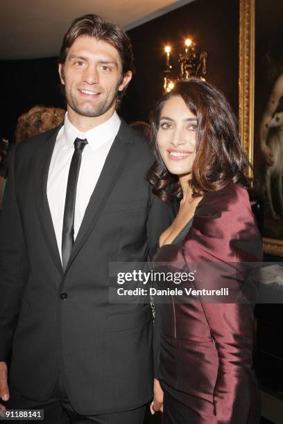 Caterina Murino and Pierre Rabadan attend the Dolce & Gabbana show as part of Milan Womenswear Fashion Week Spring/Summer 2010 on September 27, 2009...