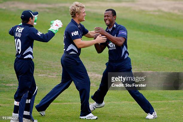 Sussex Sharks bowler Dwayne Smith celebrates with wicketkeeper Andy Hodd and Rory Hamilton-Brown after taking the wicket of Vikram Solanki off his...