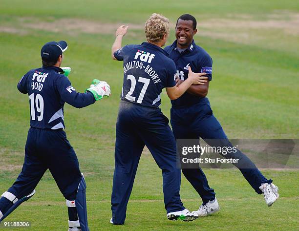 Sussex Sharks bowler Dwayne Smith celebrates with wicketkeeper Andy Hodd and Rory Hamilton-Brown after taking the wicket of Vikram Solanki off his...