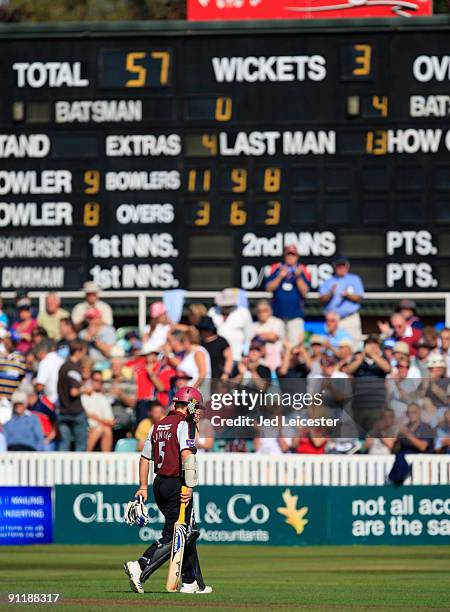 Former Australia batsman and retiring Somerset captain Justin Langer walks past the scoreboard as he leaves the pitch for the final time after making...