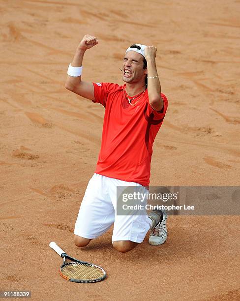 Albert Montanes of Spain drops to his knees after wining the Final against Juan Monaco of Argentina during the BCR Open Romania at the BNR Arena on...