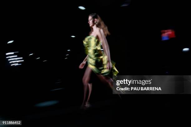 Model presents a creation by Ze Garcia during the 080 Barcelona Fashion Week in Barcelona on January 29, 2018. / AFP PHOTO / PAU BARRENA