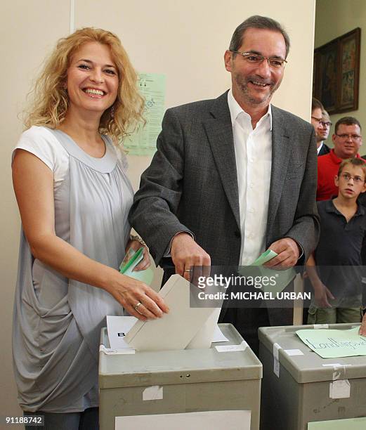 Brandenburg State Premier Matthias Platzeck and his wife Jeanette Jesorka cast their ballots at a polling station during parliamentary elections and...
