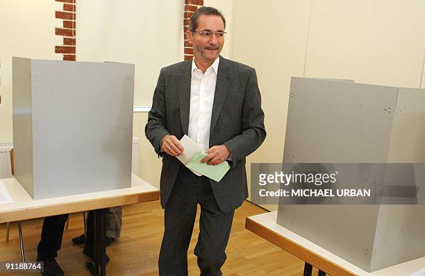 Brandenburg State Premier Matthias Platzeck prepares to cast his ballot at a polling station during parliamentary elections and regional elections in...