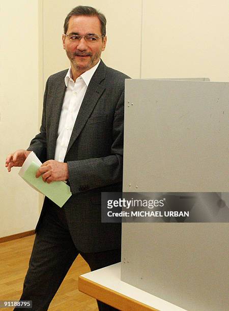 Brandenburg State Premier Matthias Platzeck prepares to cast his ballot at a polling station during parliamentary elections and regional elections in...