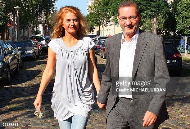 Brandenburg State Premier Matthias Platzeck and his wife Jeanette Jesorka leave after casting their ballots at a polling station during parliamentary...