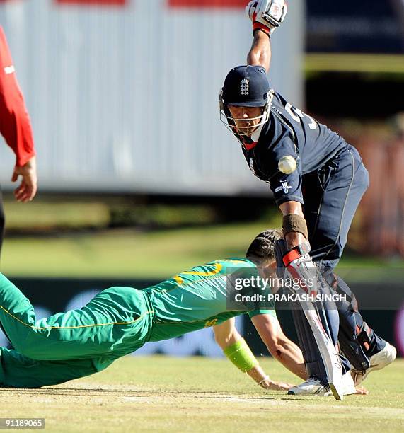 England's batsman Owais Shah watches as South African's bowler Johan Botha makes an unsuccessful attempt to stop a shot by Paul Collingwood during...