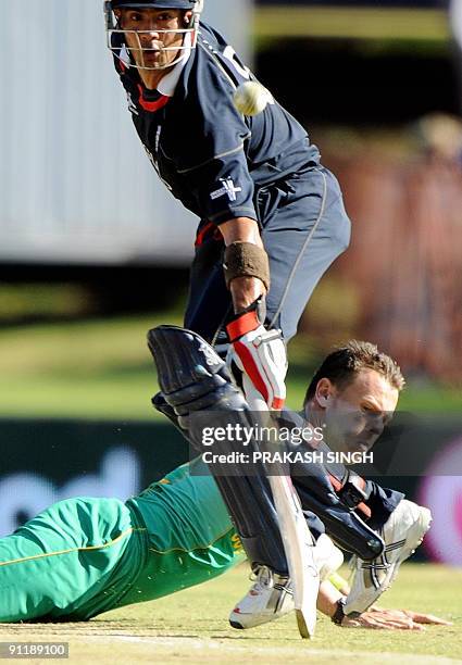 England's batsman Owais Shah watches as South African's bowler Johan Botha makes an unsuccessful attempt to stop a shot by Paul Collingwood during...