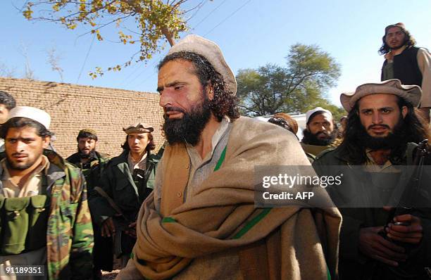 In this picture taken on December 23 banned militant organisation Lashkar-e-Islam head Mangal Bagh is escorted by bodyguards to talk to media...