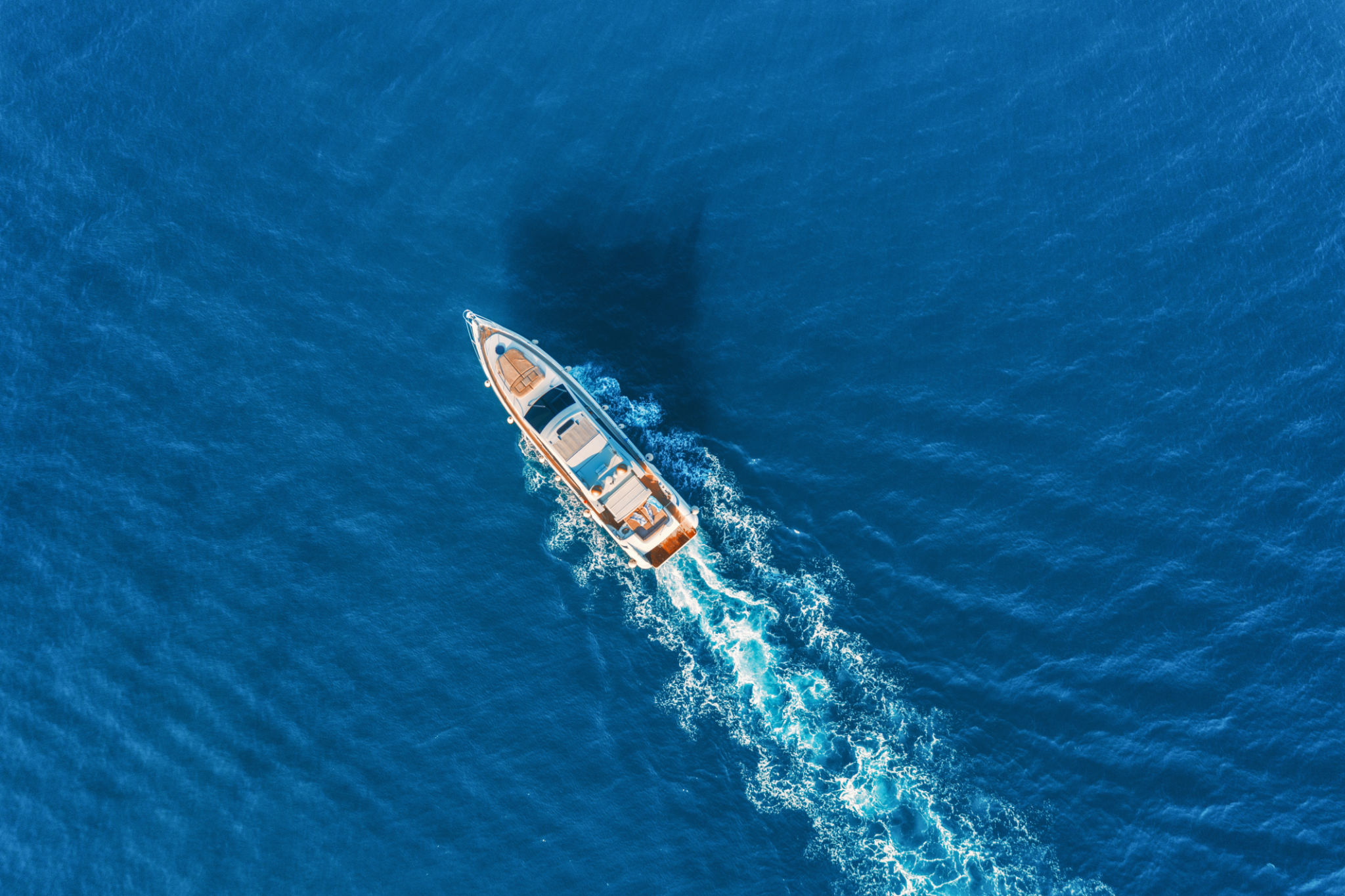 Yacht at the sea in Europe. Aerial view of luxury floating ship at sunset. Colorful landscape with boat in marina bay, blue sea. Top view from drone of yacht. Luxury cruise. Seascape with motorboat Yacht at the sea in Europe. Aerial view of luxury floating ship at sunset. Colorful landscape with boat in marina bay, blue sea. Top view from drone of yacht. Luxury cruise. Seascape with motorboat
