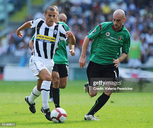 Sebastian Giovinco Amauri of Juventus FC is challenged by Roberto Guana of Bologna FC during the Serie A match between Juventus FC and Bologna FC at...