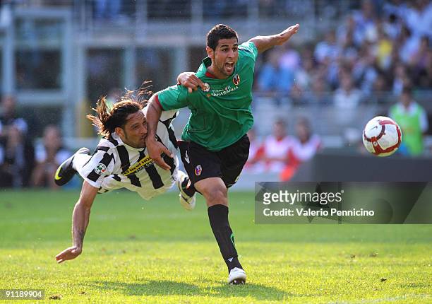Carvalho De Oliveira Amauri of Juventus FC battles for the ball with Miguel Britos of Bologna FC during the Serie A match between Juventus FC and...