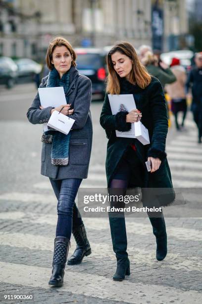 Guest wears a gray coat, leather pants, leather boots, a scarf ; a guest wears a green coat, green suede boots, outside Chanel, during Paris Fashion...