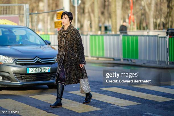 Guest wears a coat, outside Chanel, during Paris Fashion Week -Haute Couture Spring/Summer 2018, on January 23, 2018 in Paris, France.