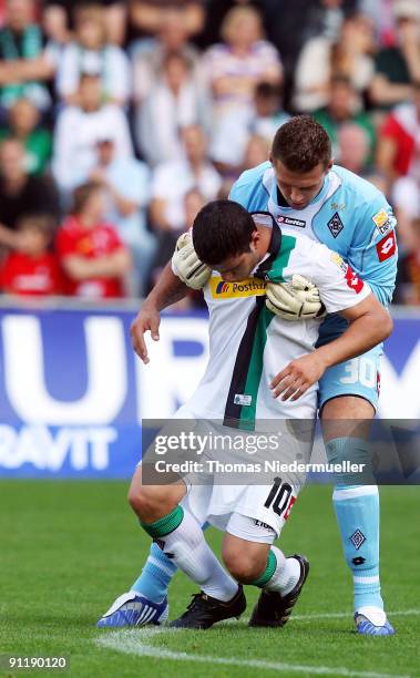Goalkeeper Logan Bailly helps his team mate Raul Bobadilla during the Bundesliga match between SC Freiburg and Borussia M'gladbach at Badenova...