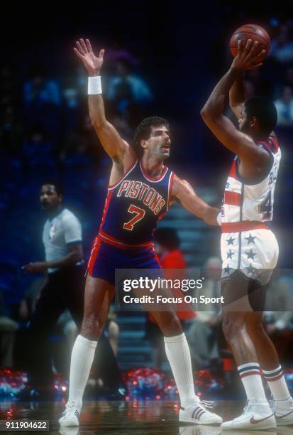 Kelly Tripucka of the Detroit Pistons closely guards Greg Ballard of the Washington Bullets during an NBA basketball game circa 1983 at the Capital...