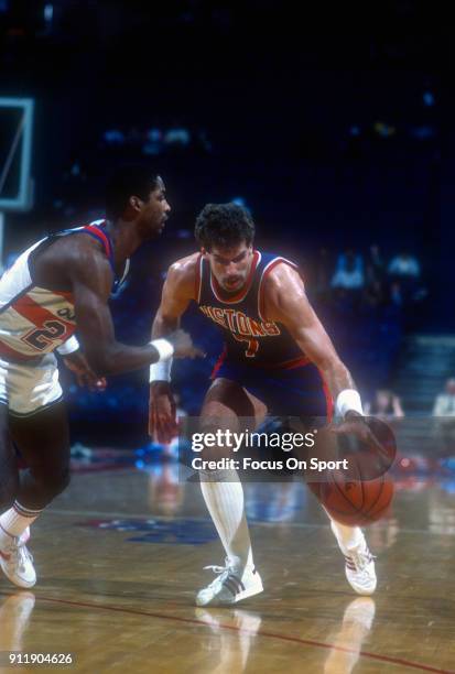 Kelly Tripucka of the Detroit Pistons dribbles the ball while guarded by Darren Daye of the Washington Bullets during an NBA basketball game circa...