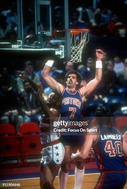 Kelly Tripucka of the Detroit Pistons fights for a rebound over Greg Ballard of the Washington Bullets during an NBA basketball game circa 1983 at...