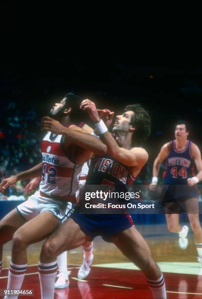 Kelly Tripucka of the Detroit Pistons fights for position with Greg Ballard of the Washington Bullets during an NBA basketball game circa 1983 at the...