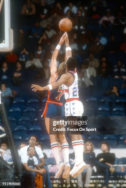 Kelly Tripucka of the Detroit Pistons battles for a rebound with Don Collins of the Washington Bullets during an NBA basketball game circa 1984 at...