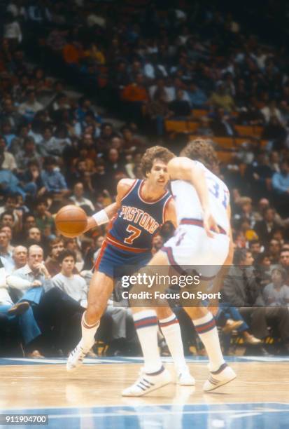 Kelly Tripucka of the Detroit Pistons looks to drive on Mike O'Koren of the New Jersey Nets during an NBA basketball game circa 1982 at the Brendan...