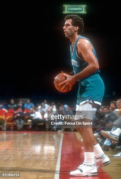 Kelly Tripucka of the Charlotte Hornets looks to pass the ball in bounds against the Washington Bullets during an NBA basketball game circa 1991 at...