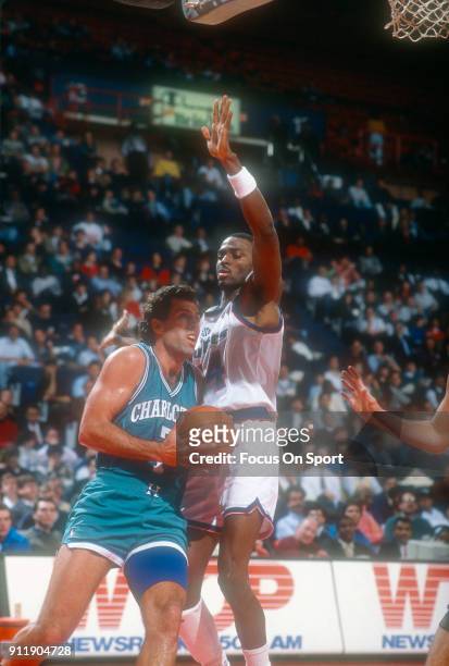 Kelly Tripucka of the Charlotte Hornets drives on Harvey Grant of the Washington Bullets during an NBA basketball game circa 1991 at the Capital...