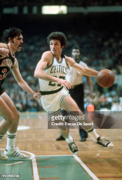 Kevin Stacom of the Boston Celtics drives on Brian Winters of the Milwaukee Bucks during an NBA basketball game circa 1976 at the Boston Garden in...
