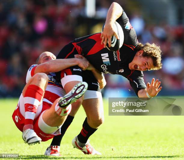 Alex Goode of Saracens is tackled by Mike Tindall of Gloucester during the Guinness premiership match between Saracens and Gloucester at Vicarage...