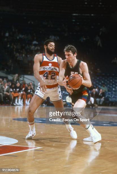 Kiki VanDeWeghe of the Denver Nuggets drives on Greg Ballard of the Washington Bullets during an NBA basketball game circa 1982 at the Capital Centre...