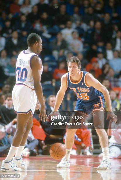 Kiki VanDeWeghe of the New York Knicks closely guards Bernard King of the Washington Bullets during an NBA basketball game circa 1992 at the Capital...